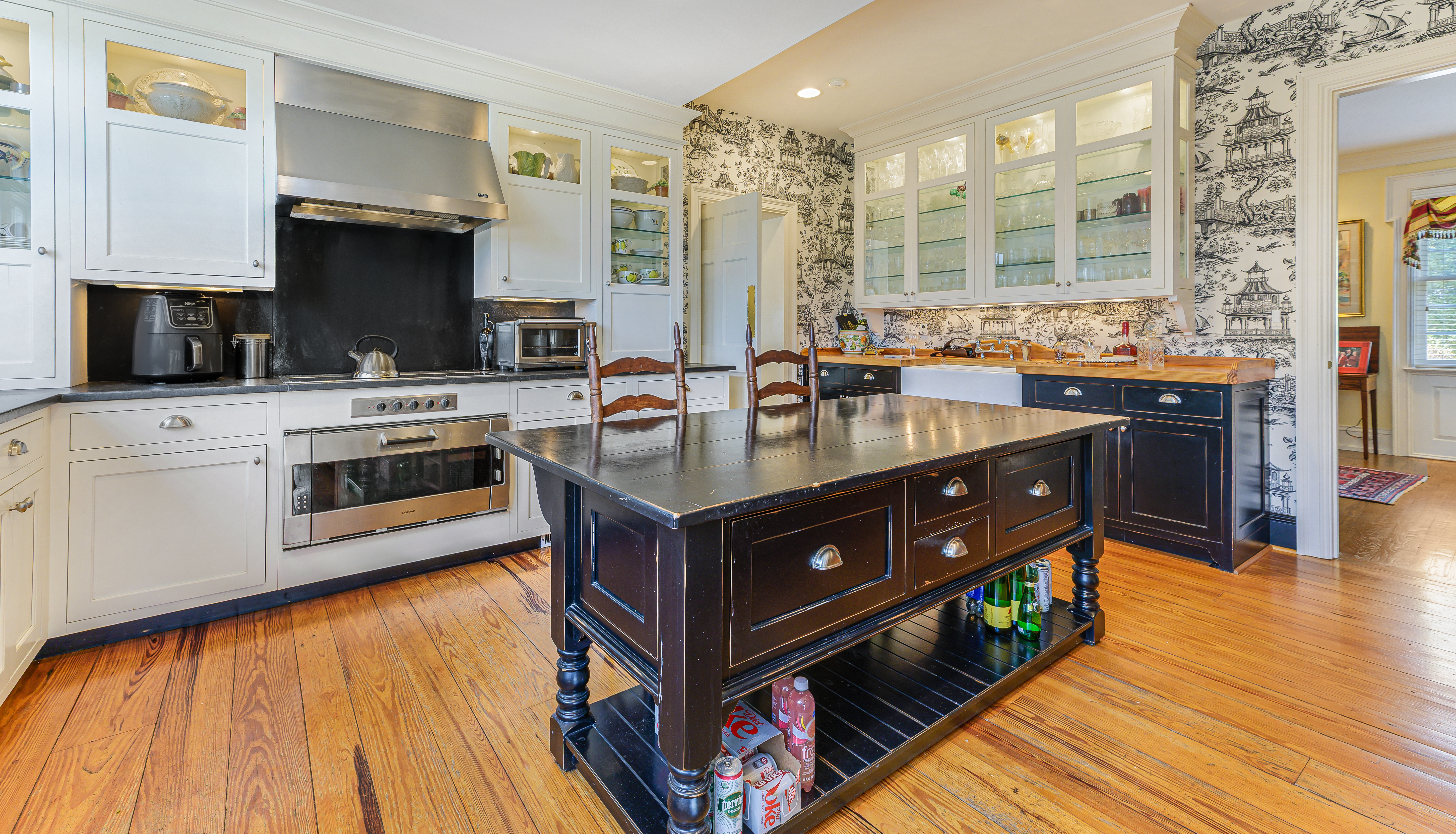 Garran Hill kitchen — white cabinetry, dark granite island, heart-pine floors