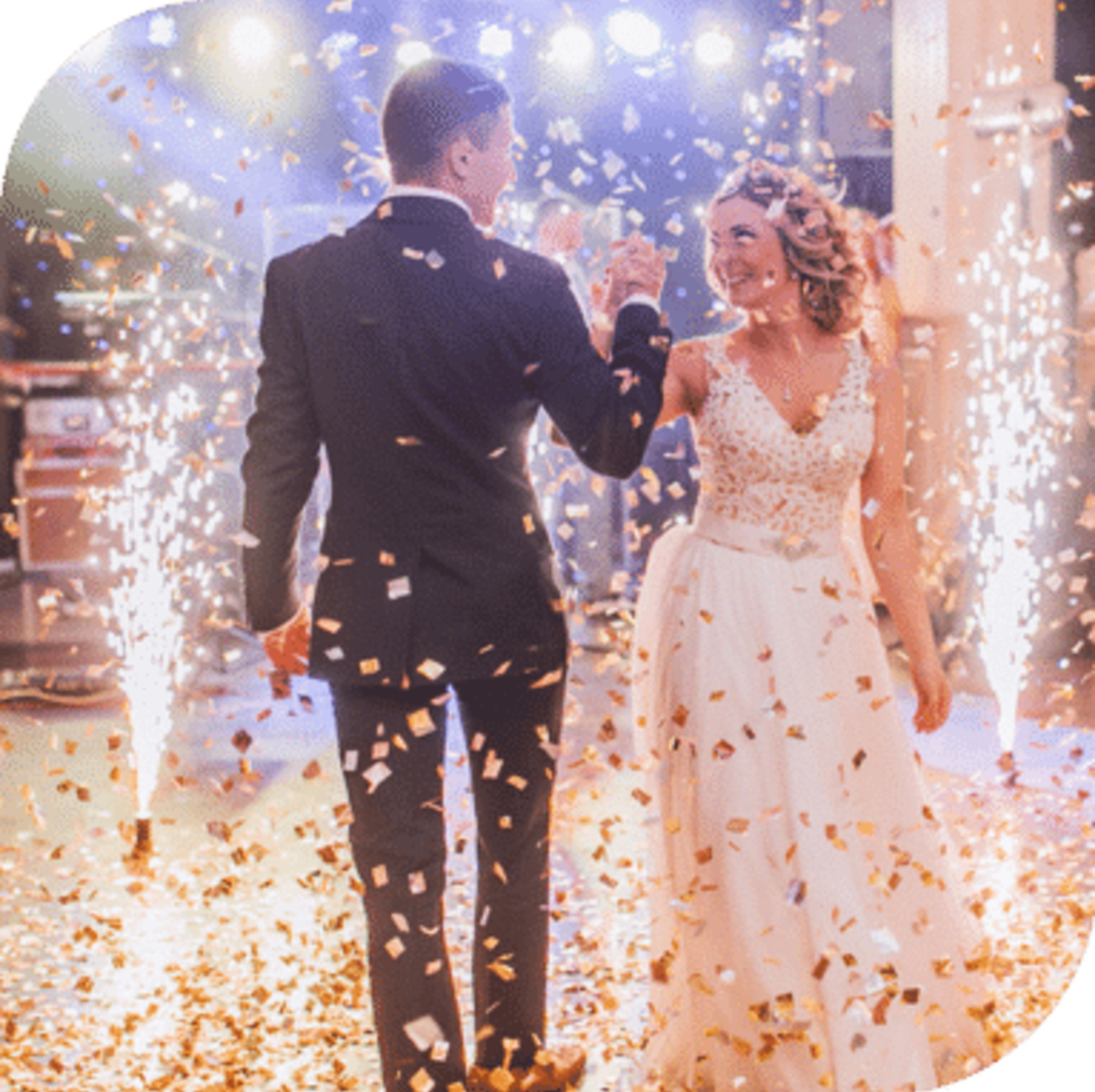 Bride and groom share their first dance surrounded by sparkling fireworks and falling confetti.