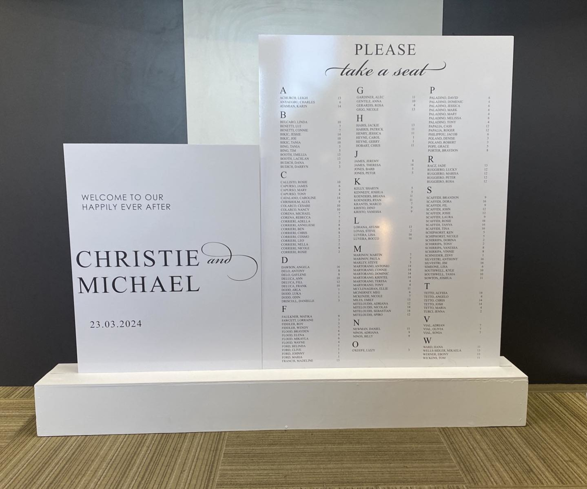 Modern white wedding welcome sign and seating chart display for Christie and Michael.