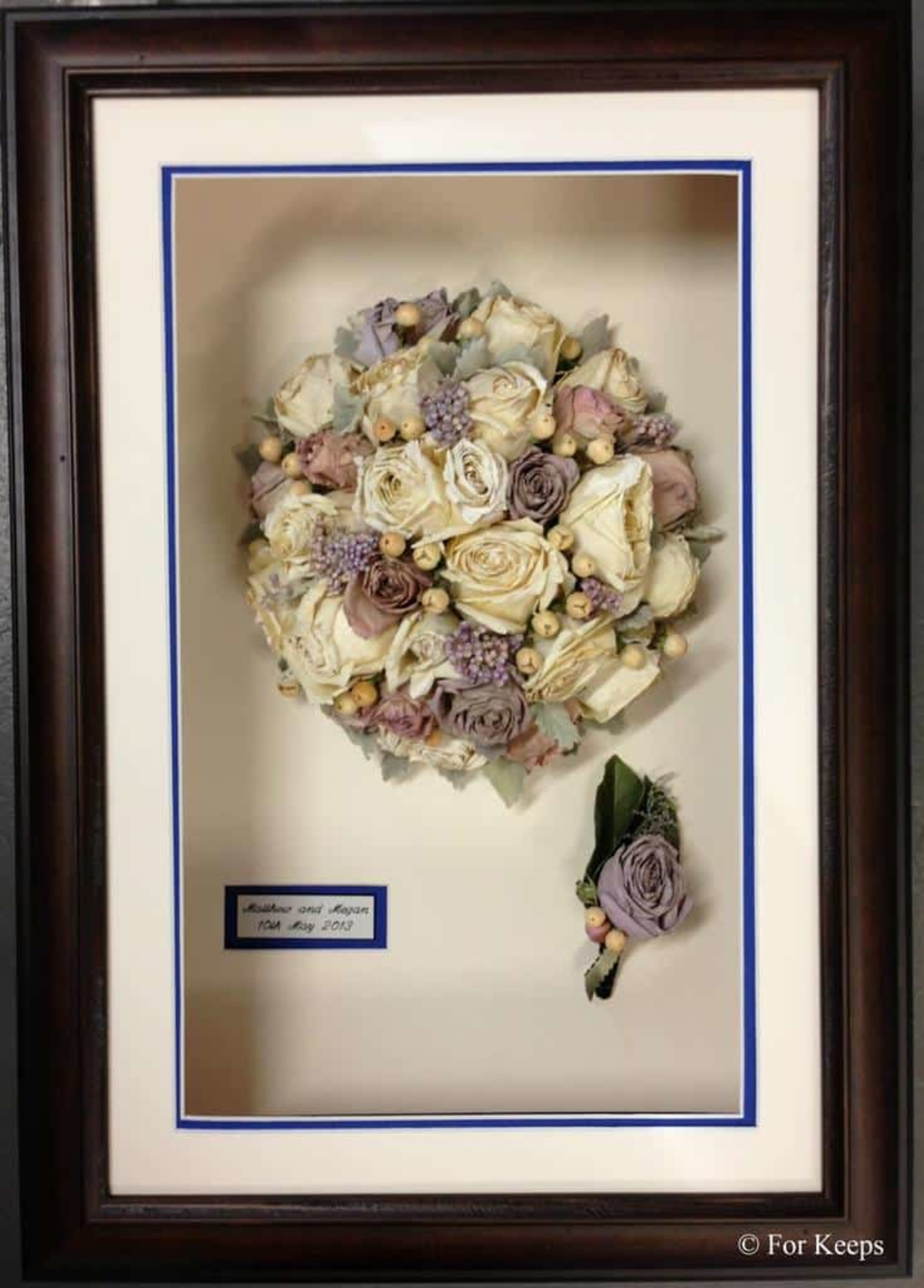 Framed preserved bridal bouquet and boutonniere displayed in a shadow box frame.
