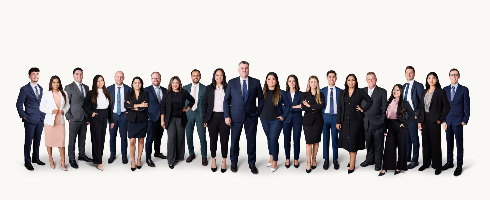 Large professional planning team posing together in formal business attire on a light background.