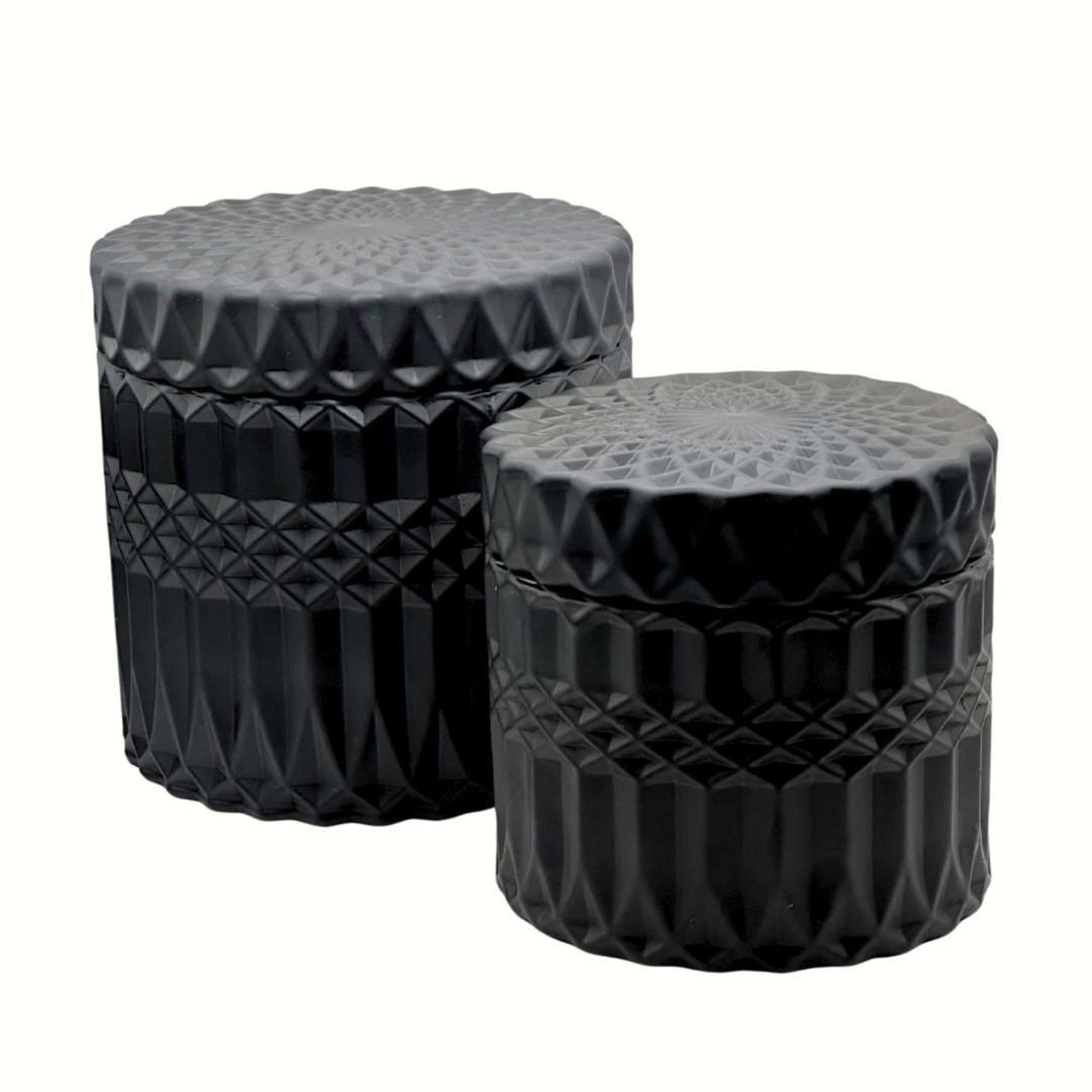 Two black textured cylindrical containers with geometric patterns used as modern wedding decor.