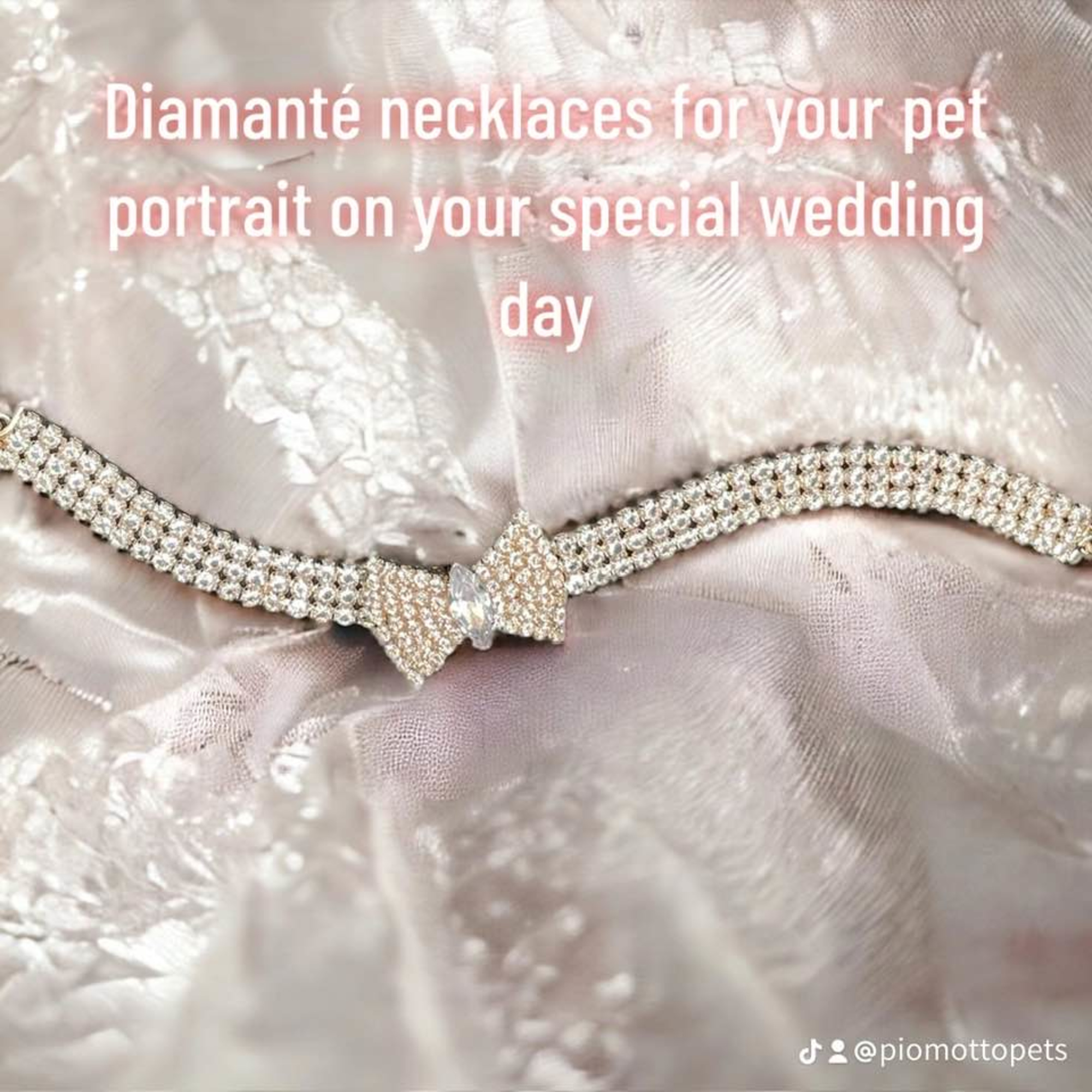 Sparkling diamanté pet necklace with bow detail displayed on shimmery wedding fabric.