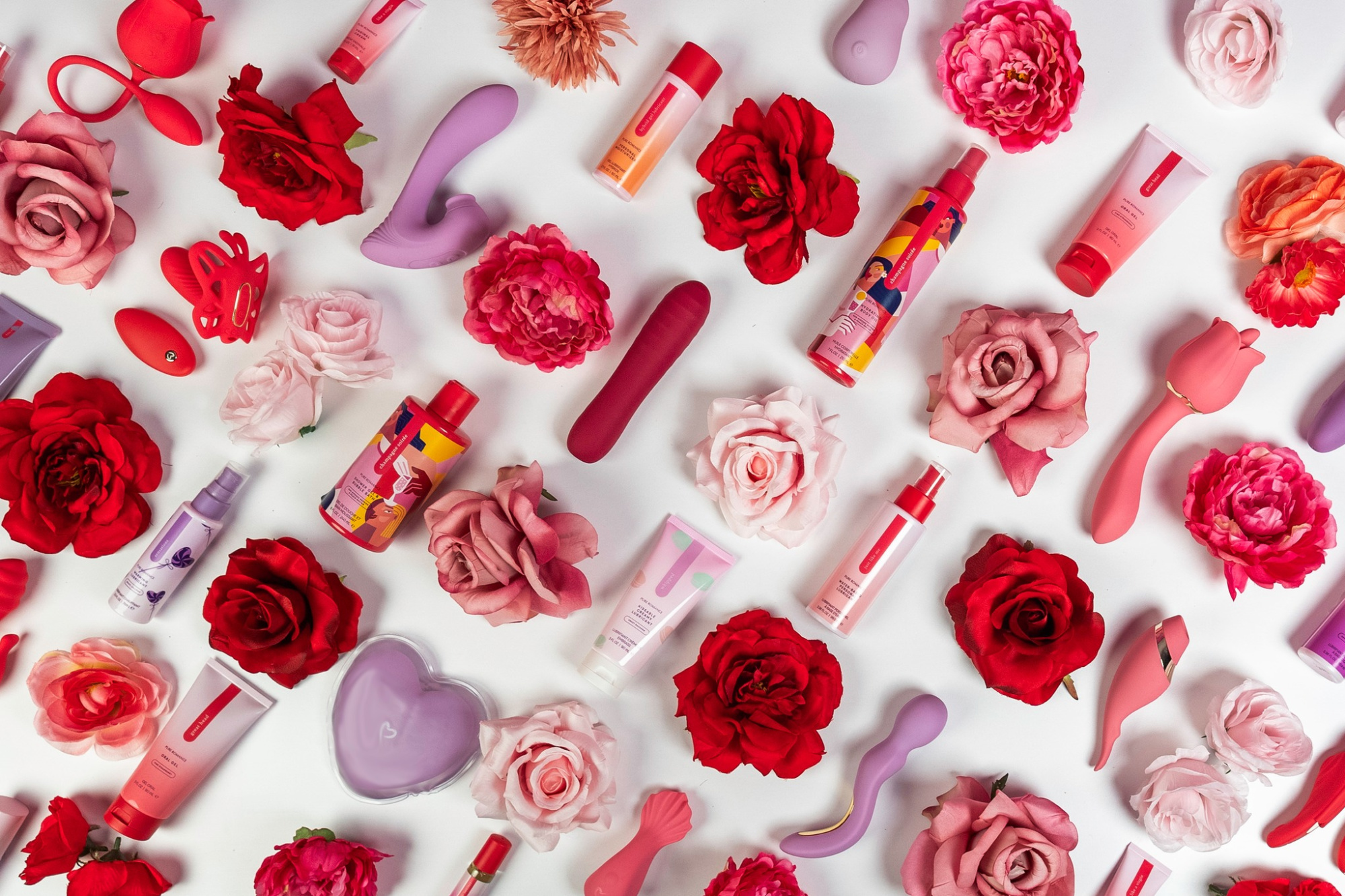 Colorful intimate products and roses arranged on a white background for a romantic bridal gift display