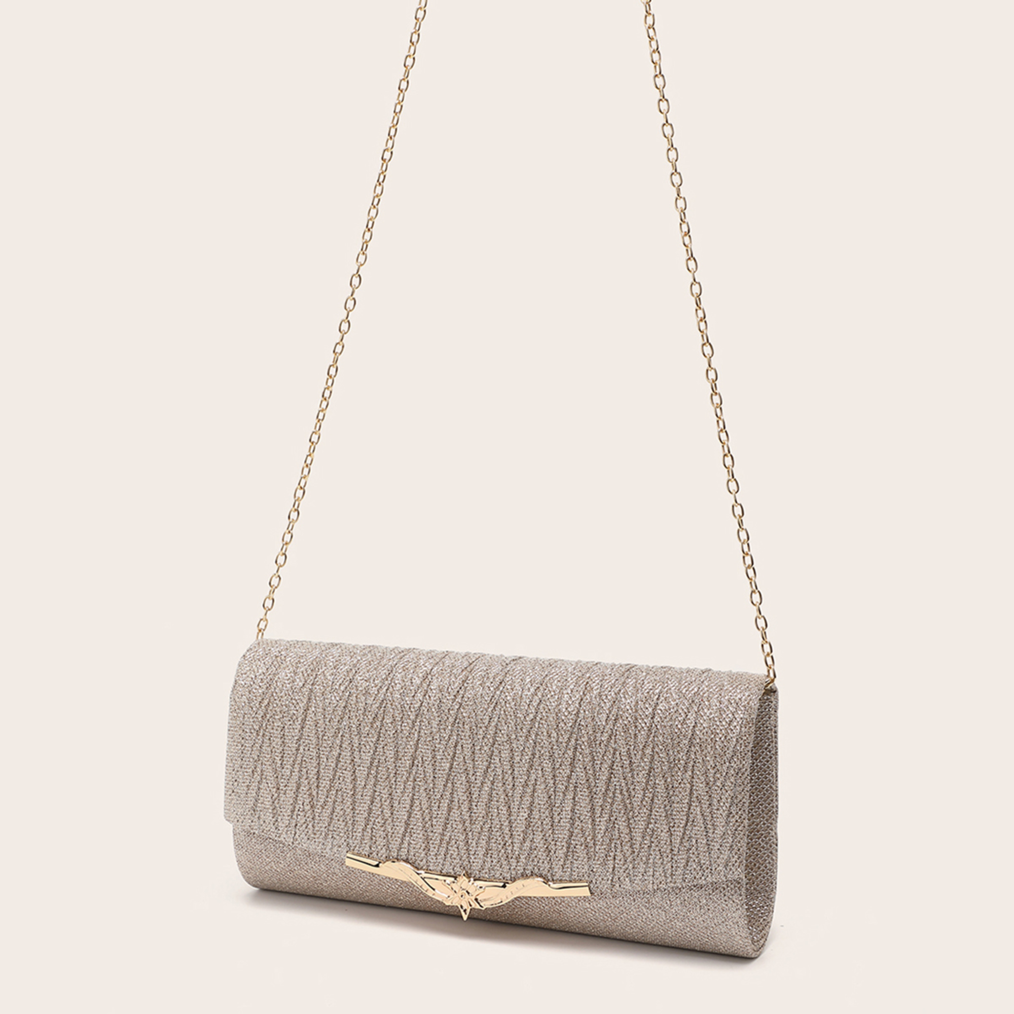 Sparkling gold evening clutch with chain strap displayed on a neutral background.
