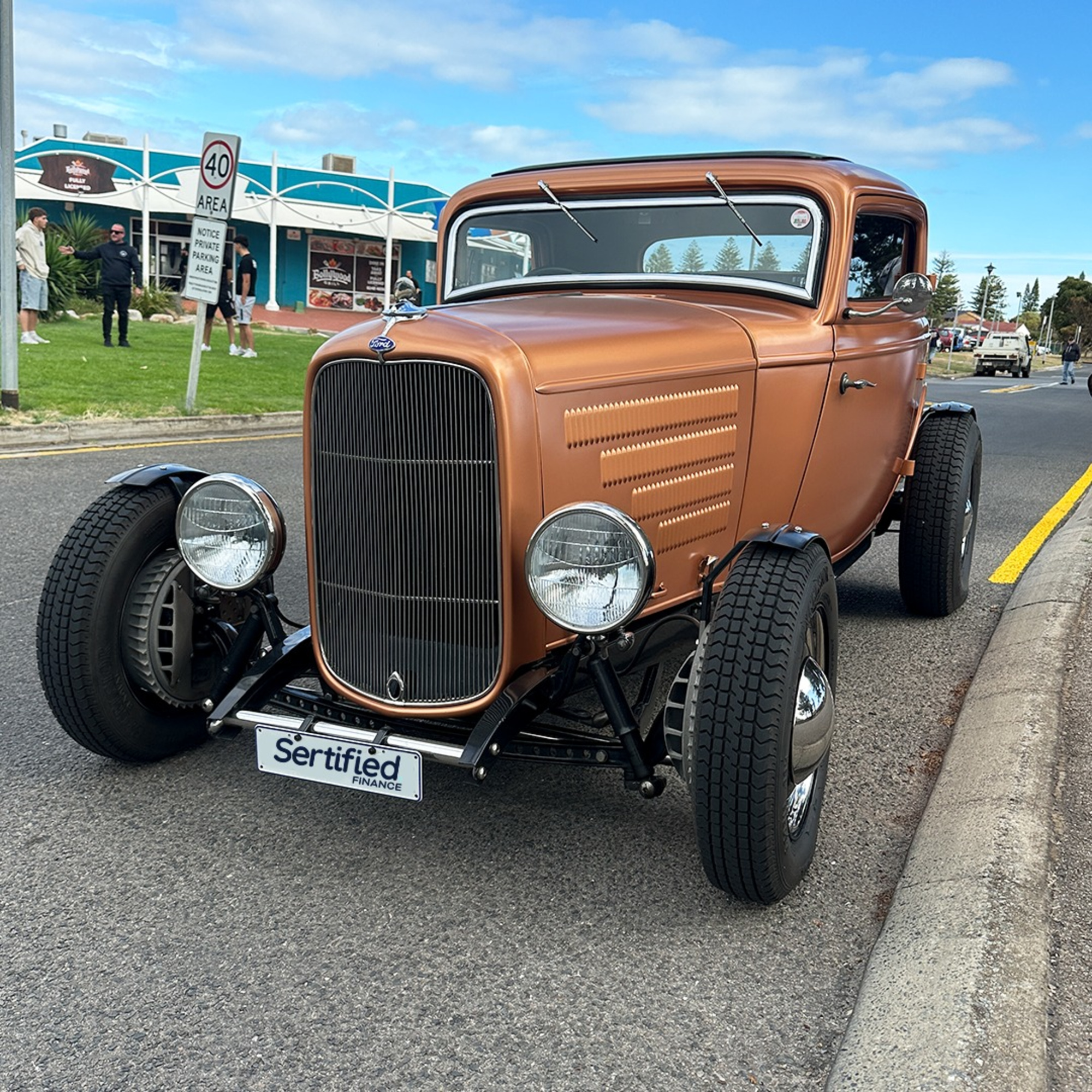 Bronze vintage hot rod parked on a street, ideal as a statement wedding getaway car.