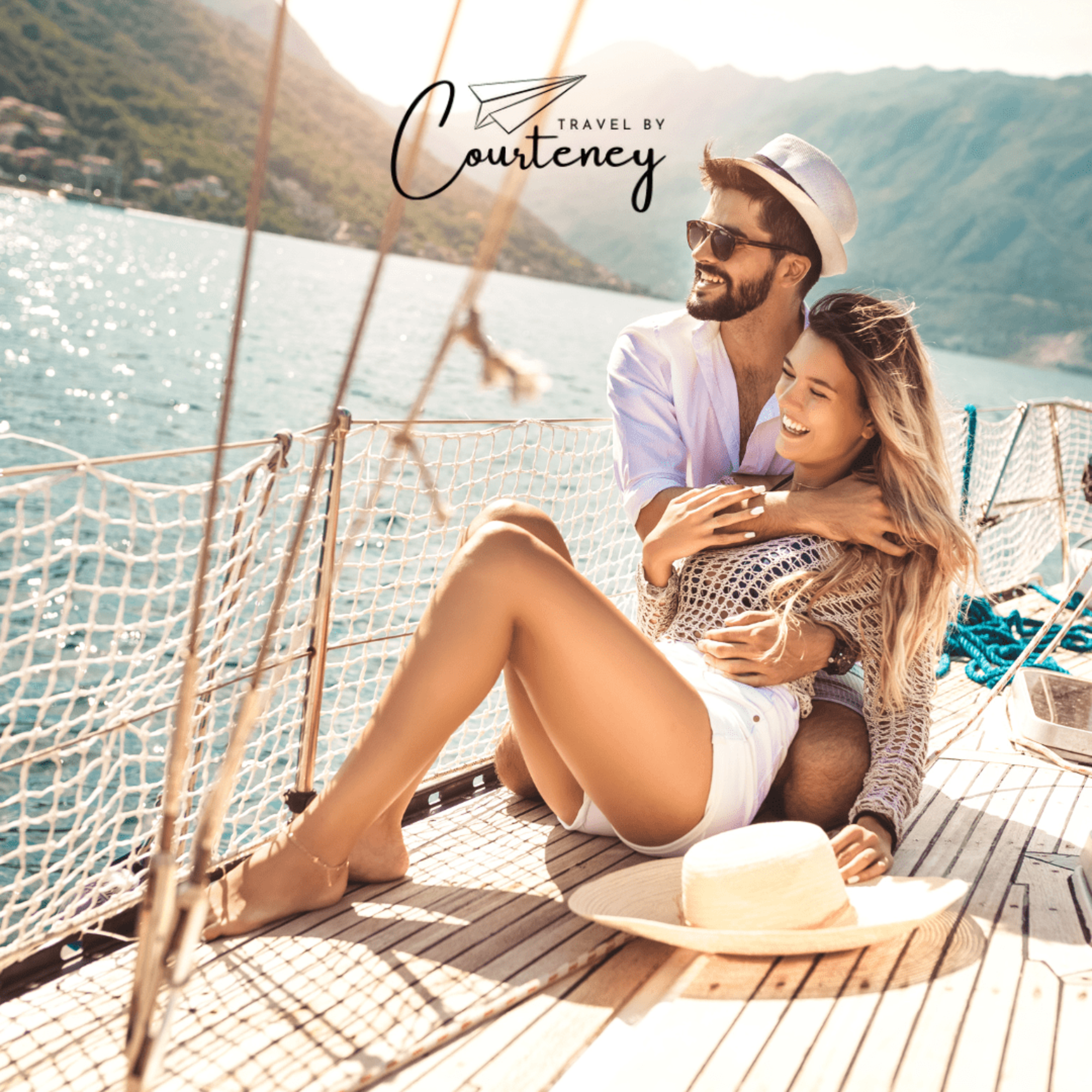Smiling couple relaxes on a sailboat during a sunny seaside honeymoon trip.