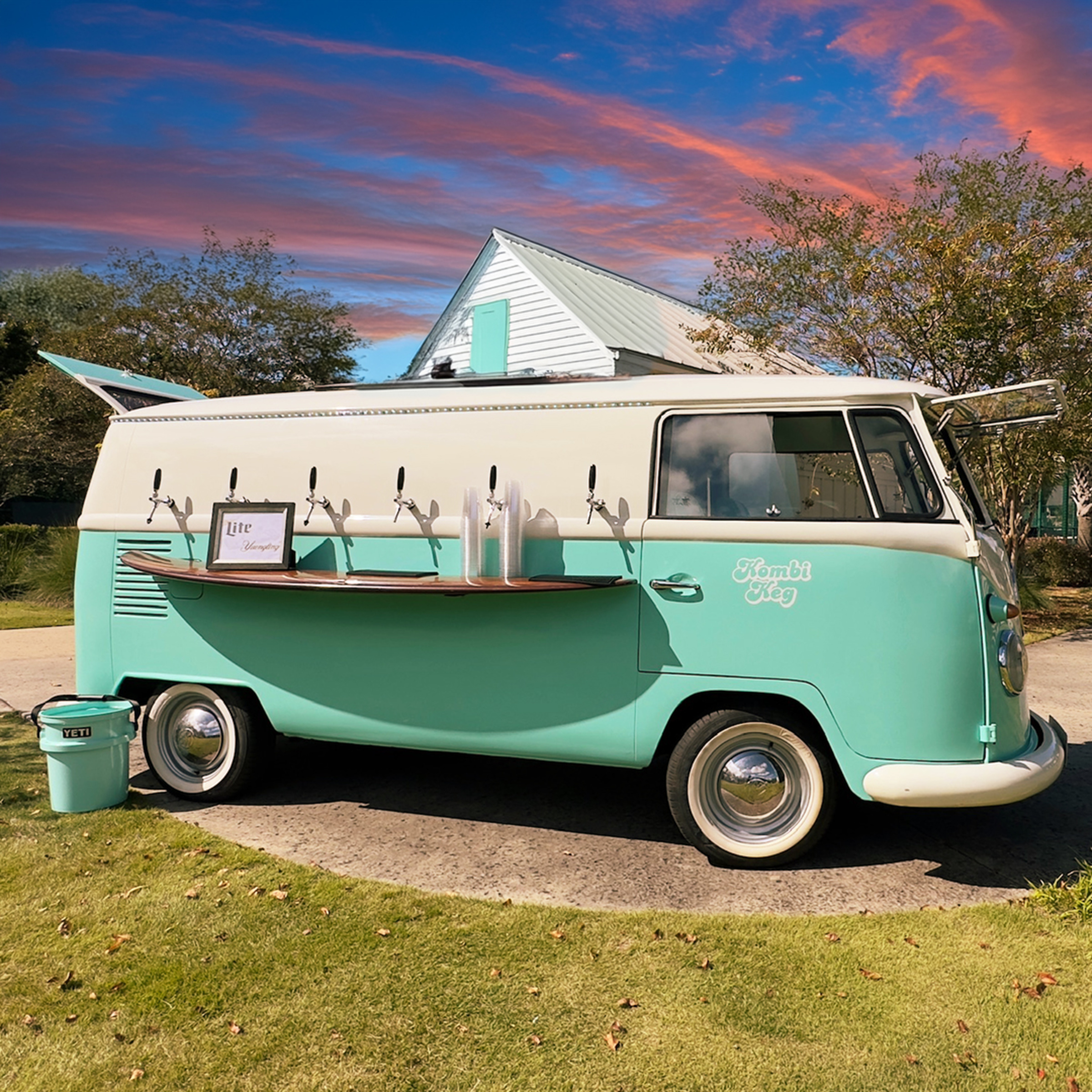 Vintage mint and cream drink truck with beer taps set up as a mobile bar at an outdoor wedding venue.