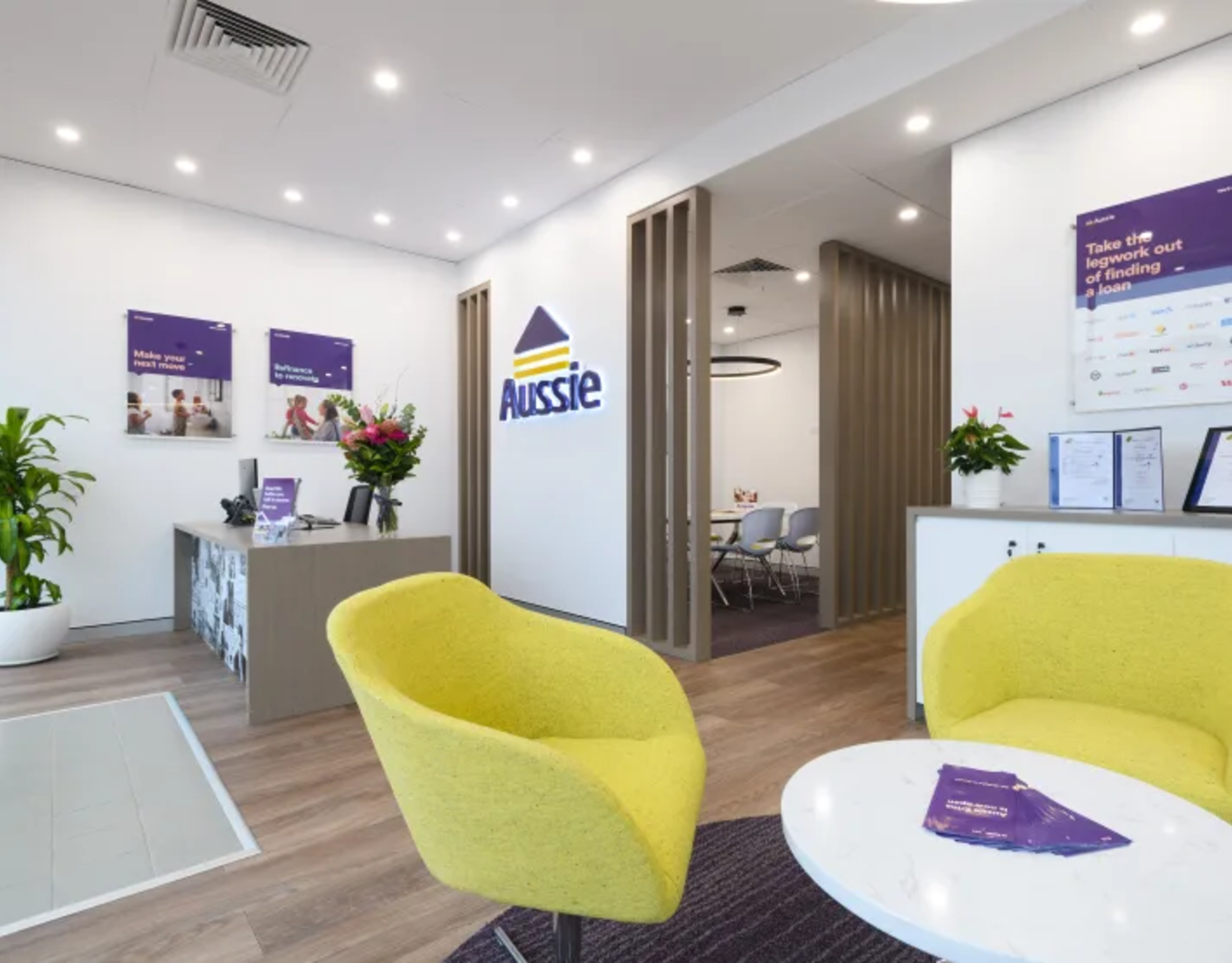Modern Aussie mortgage office interior with bright yellow chairs and consultation area.