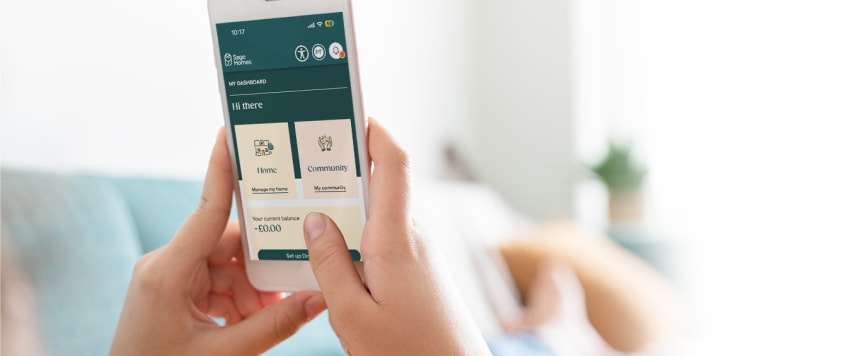 Someone holding a mobile phone showing Sage Homes portal