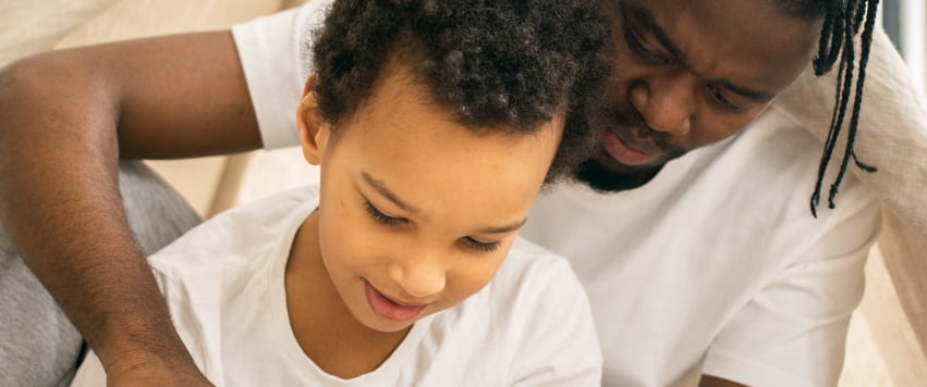 man teaching boy how to read