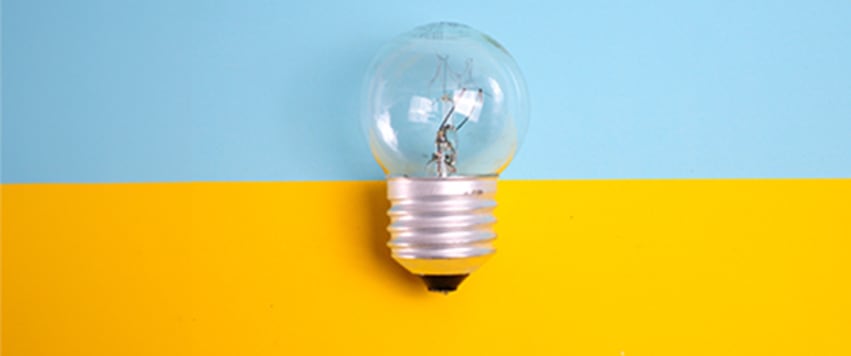 Lightbulb on yellow and blue blackground