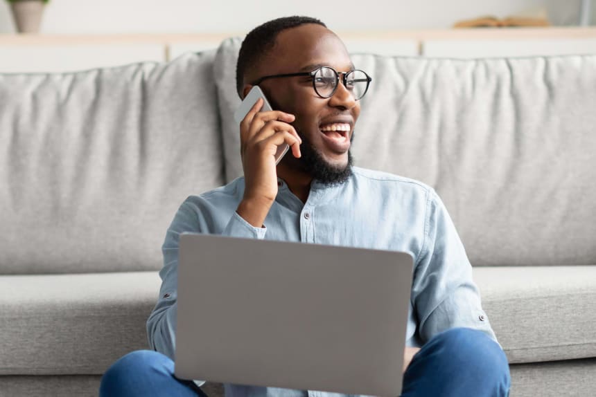 man on phone and laptop