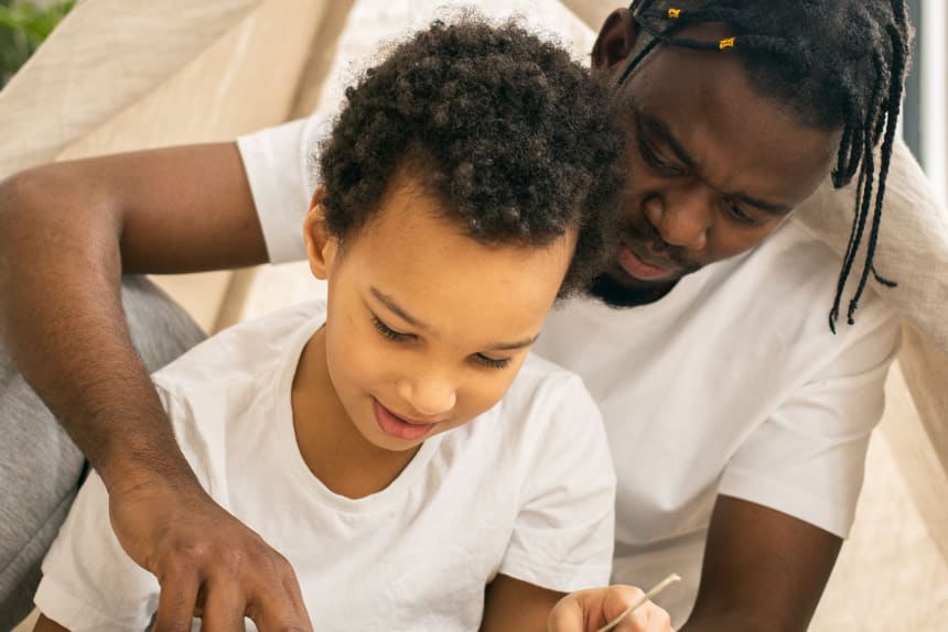 man teaching boy how to read