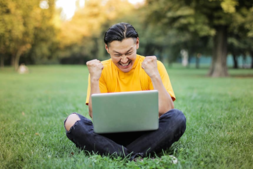 Happy man looking at laptop