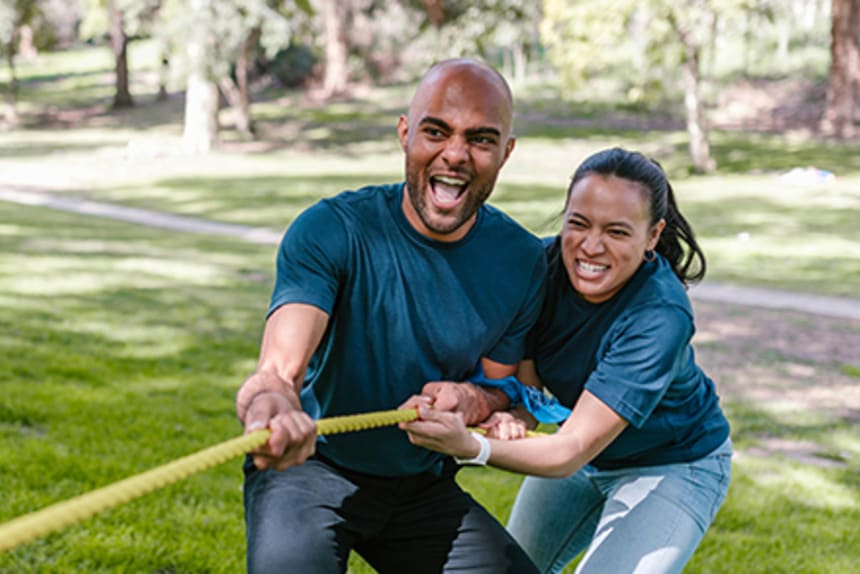 man and woman playing tug of war