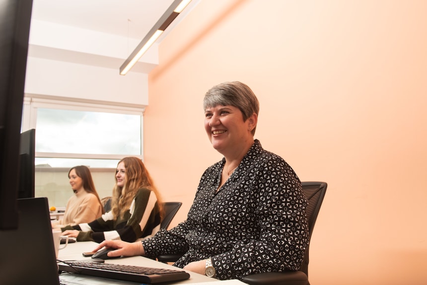 lady sitting in front of desktop