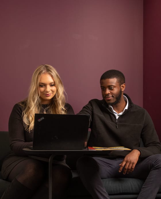 man and woman looking at laptop