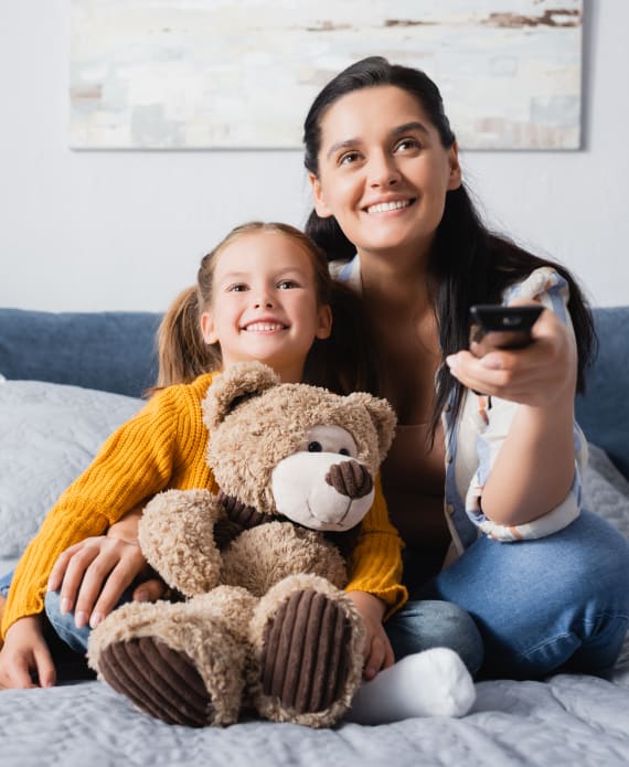 Mum and daughter watch TV together