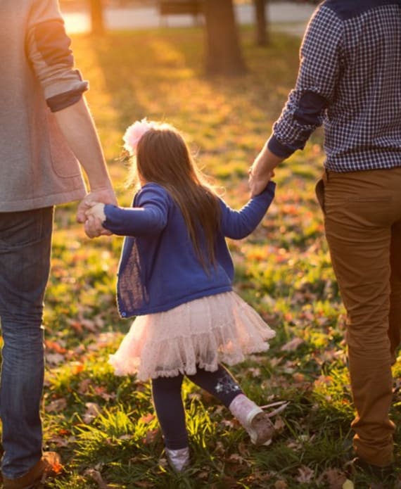 little girl in tutu dress with family