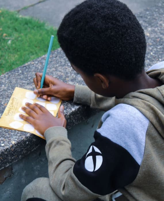 Backview of boy writing on paper