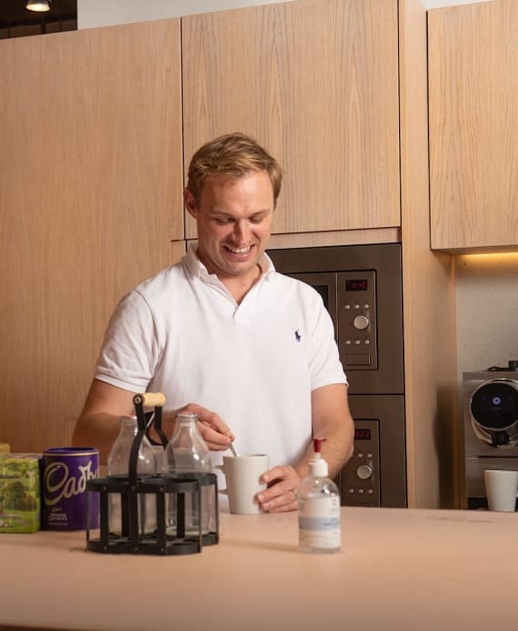 man in kitchen making tea