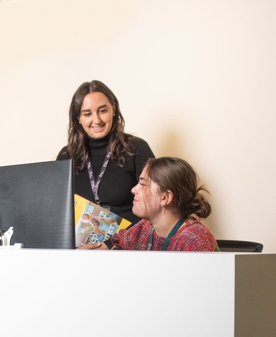 Two ladies behind front desk