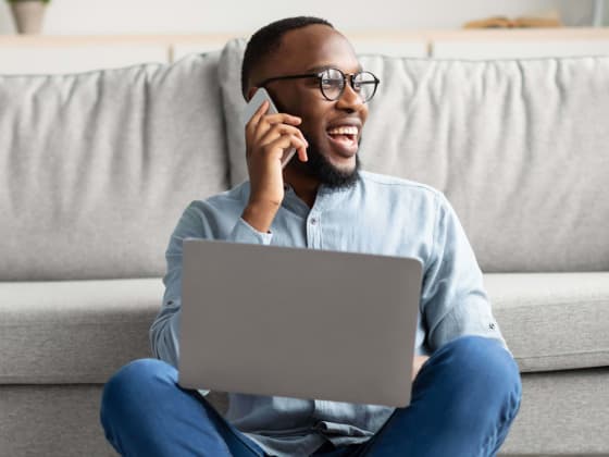 man on phone and laptop