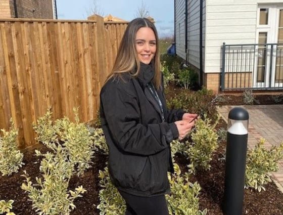 A Sage Homes female employee outside a property