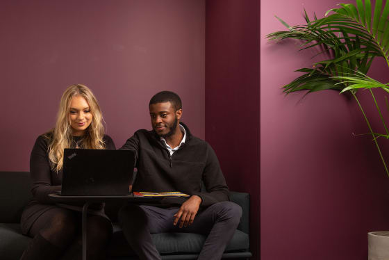 man and woman looking at laptop