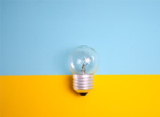 Lightbulb on yellow and blue blackground