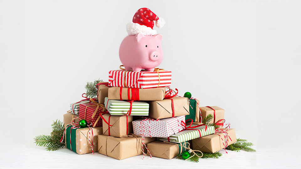 Festive piggy bank on top of Christmas presents