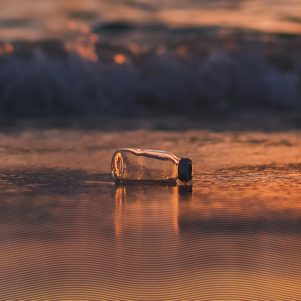 glass bottle lying in water