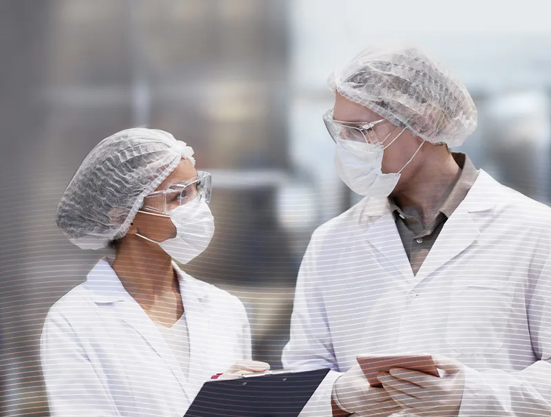 two-people-in-a-factory-setting-using-hydrachem-uniforms