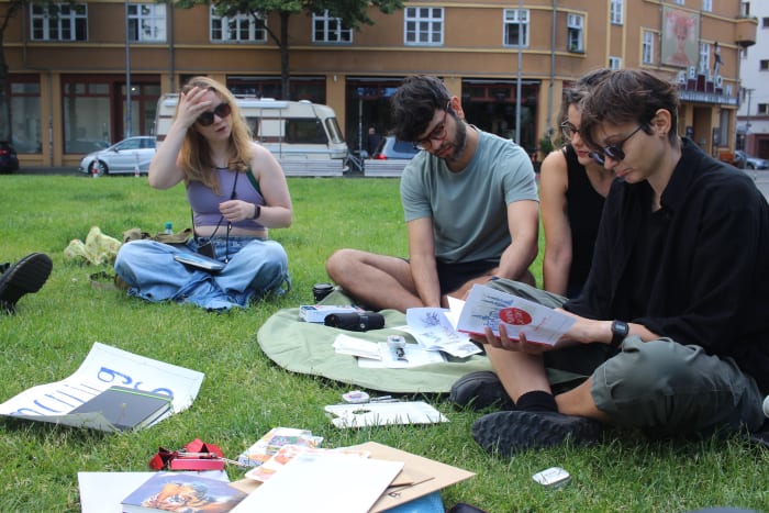 Sketching on the grass with books and paper around