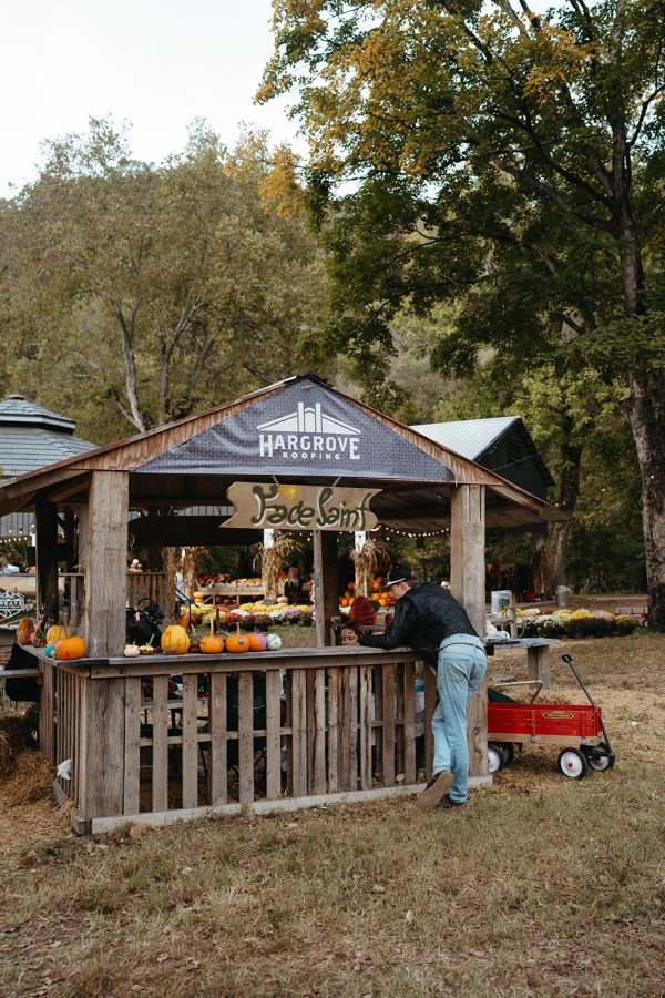 Wooden market stand with pumpkins and a red wagon