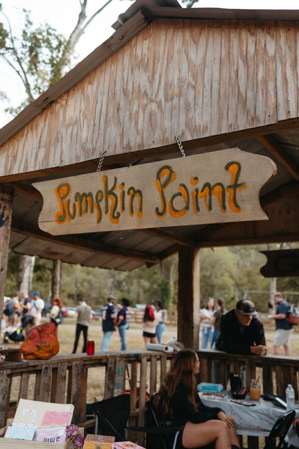 Hand-painted “Pumpkin Point” sign over the pumpkin stand