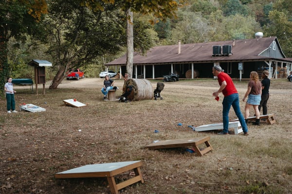 Families playing cornhole on the lawn