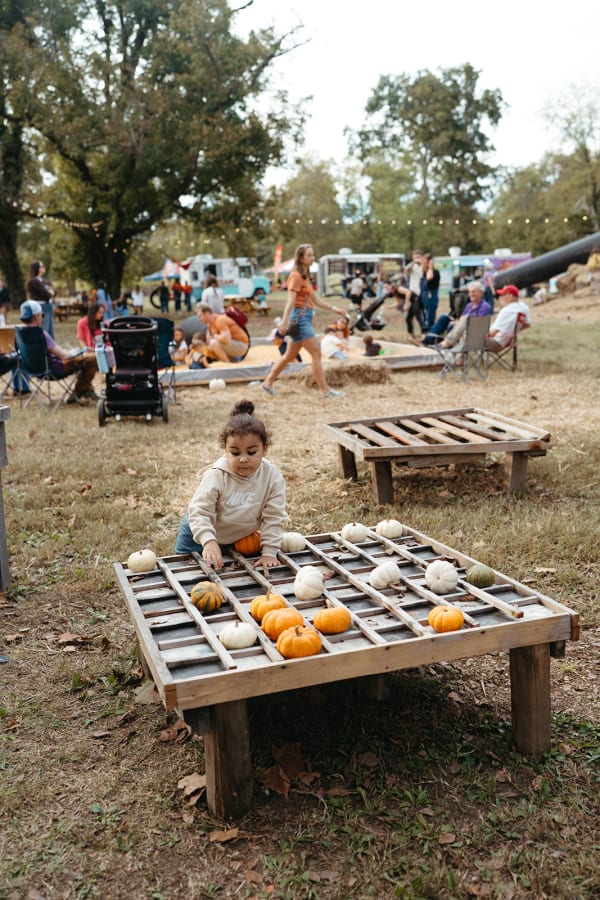 Child playing pumpkin tic-tac-toe