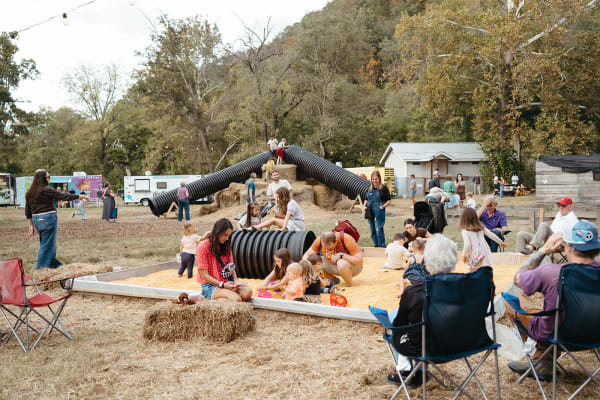 Families relaxing beside the corn pit