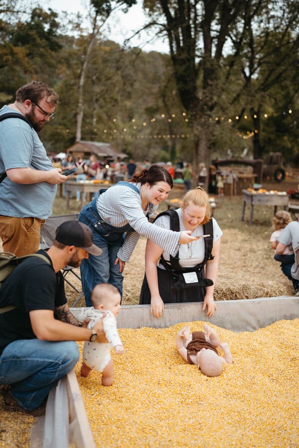 Parents and babies playing in the corn pit