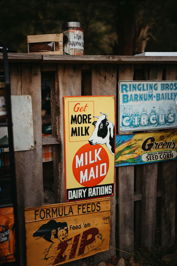 Vintage tin signs on a rustic wooden wall