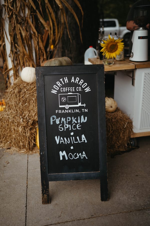 Coffee cart with a pumpkin spice menu chalkboard