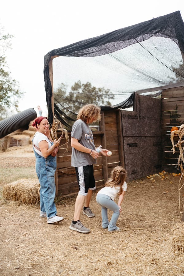 Family exploring a rustic wooden play area