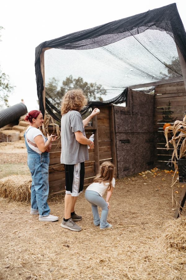 Family exploring a rustic wooden play area