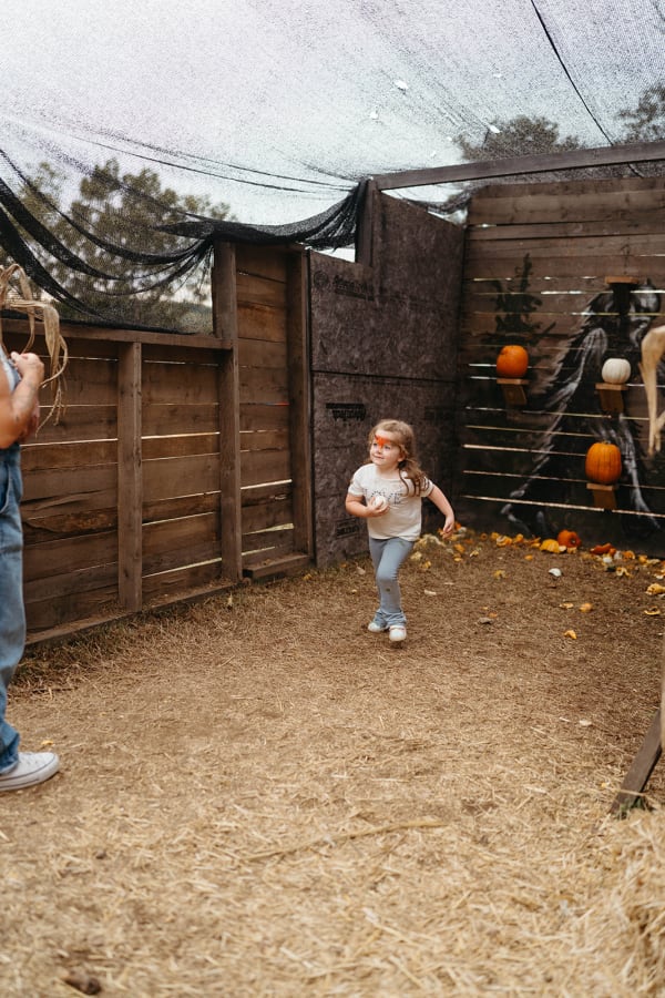 Family exploring a rustic wooden play area