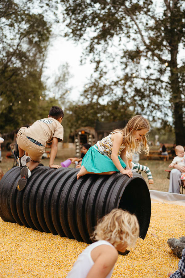 Kids climbing over the tunnel in the corn pit