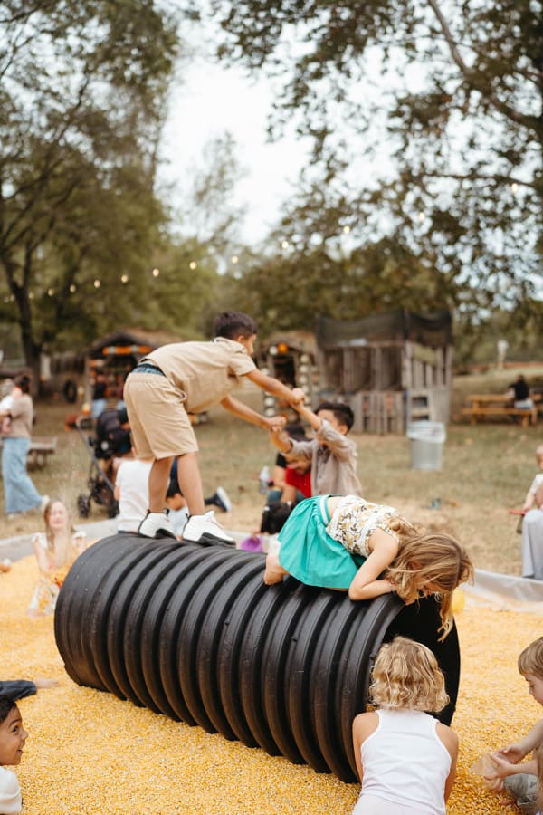 Kids climbing over the tunnel in the corn pit