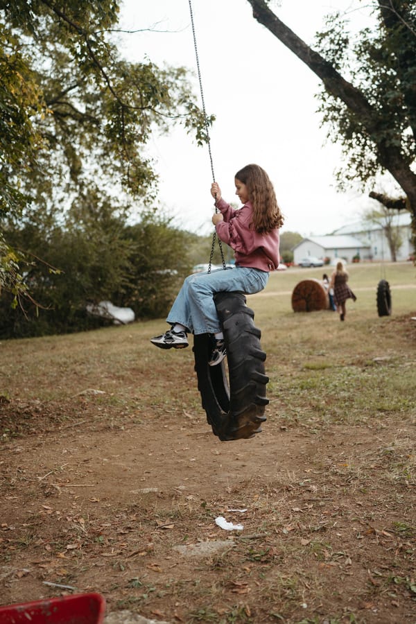 Girl swinging on the tire swing