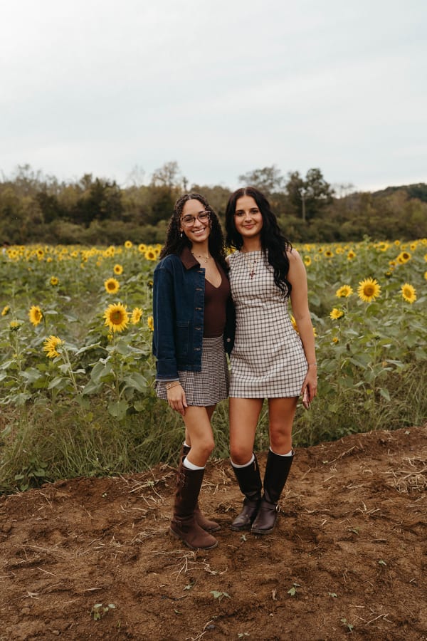 Two friends posing in the sunflower field
